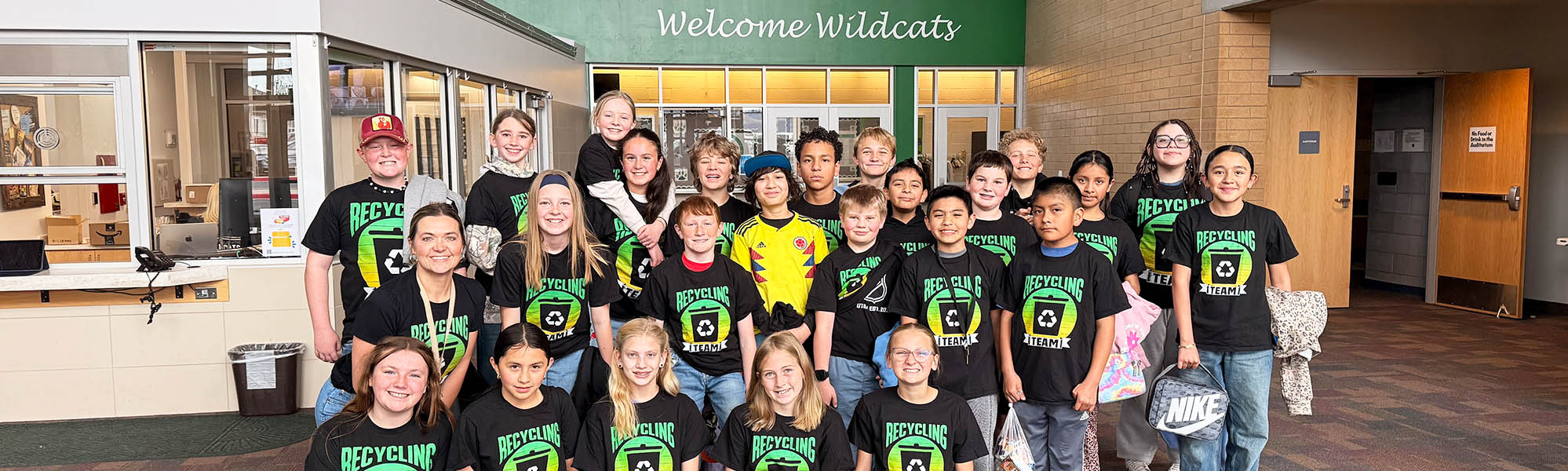 Group of students wearing recycling t-shirts