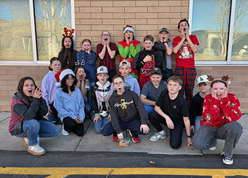 Group of students posing for a picture outside
