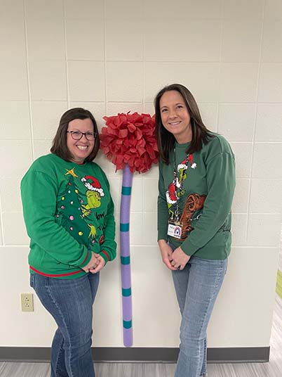 Two staff members in dr. Suess shirts