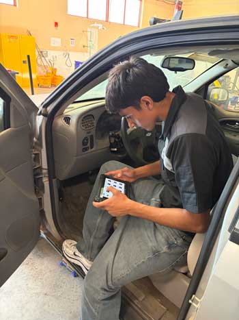 Student diagnosing a car