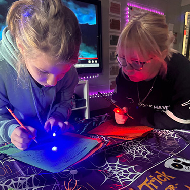 students working on a Halloween decorated table