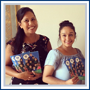 two teachers holding welcome brochures