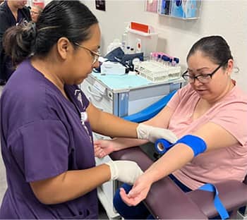 student taking someone's blood