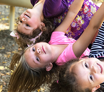 Three happy girls on the playground
