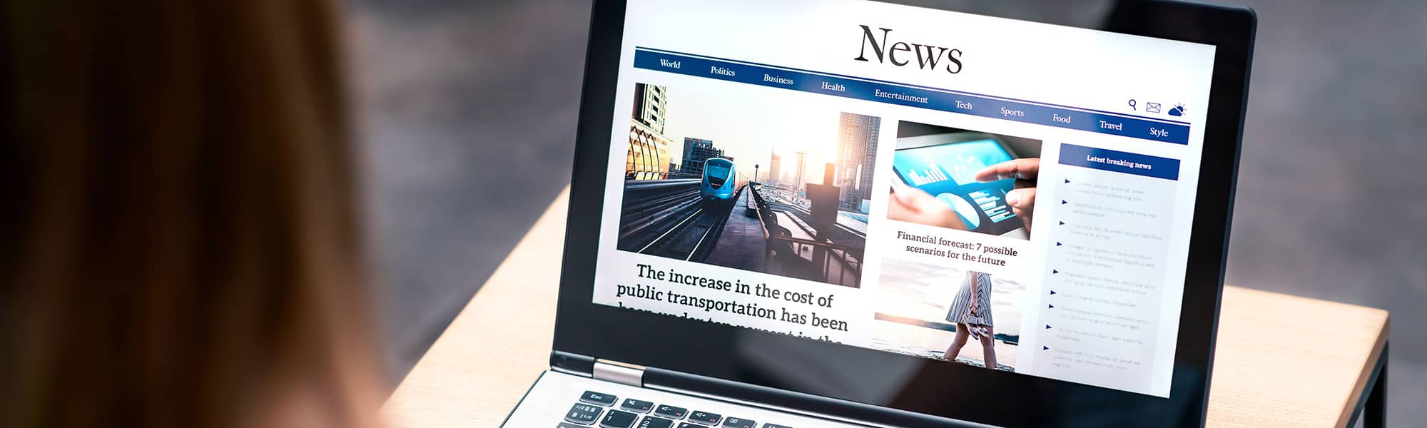 Woman viewing news on laptop