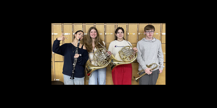 Four students posing for a picture that were selected for the Umass Amherst Honors Band Festival