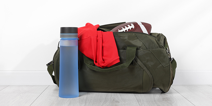Fall sports gym bag with football and water bottle