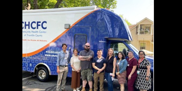 CHCFC Mobile Health Clinic with group of happy workers
