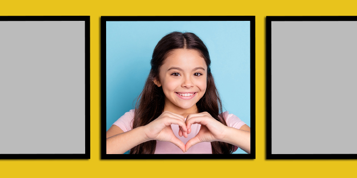 Happy elementary school girl posing for a school picture