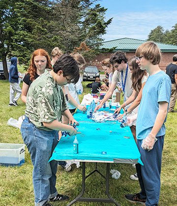 Students enjoying tie dying activity during field day