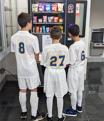 MTRS soccer players in front of a vending machine
