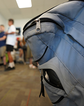 Close up of a blue backpack in the classroom