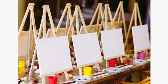Art canvases set up on a table for a Paint & Sip event