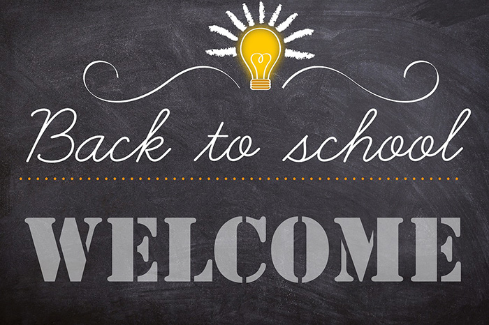 Chalkboard background with a lightbulb and Back to school - Welcome written on it