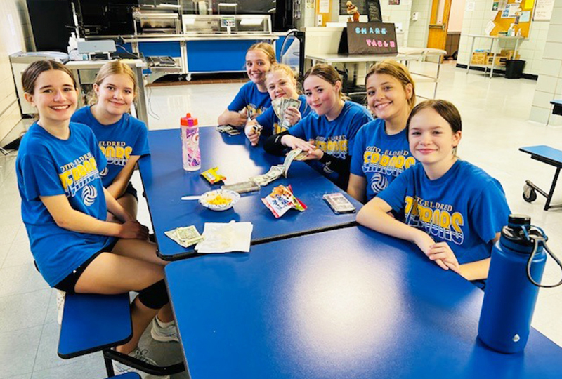 Happy students in cafeteria Happy students sitting at a blue table in the cafeteria
