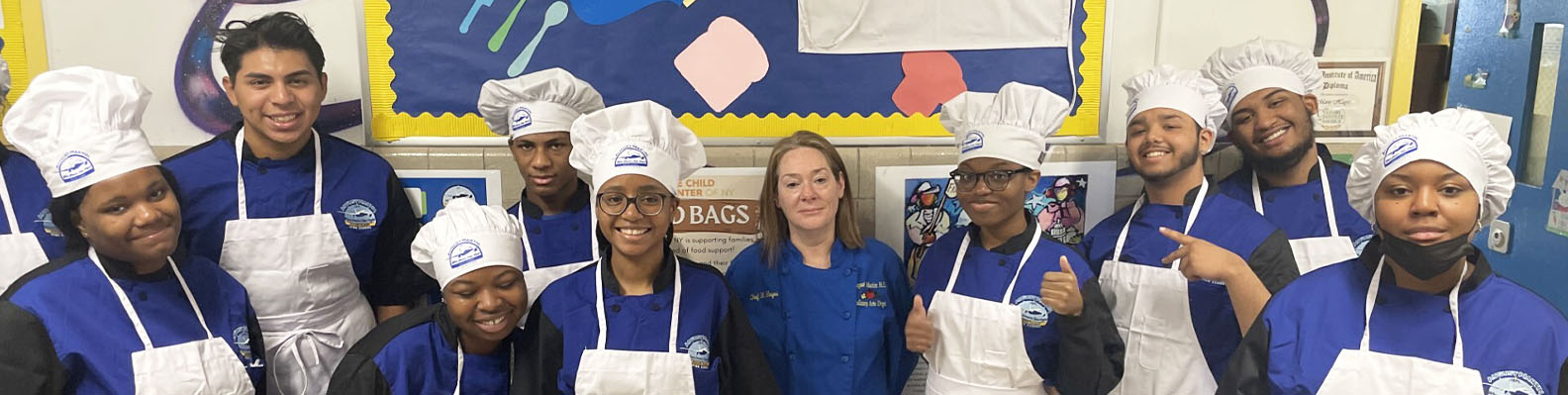 Group of happy students wearing chef hats