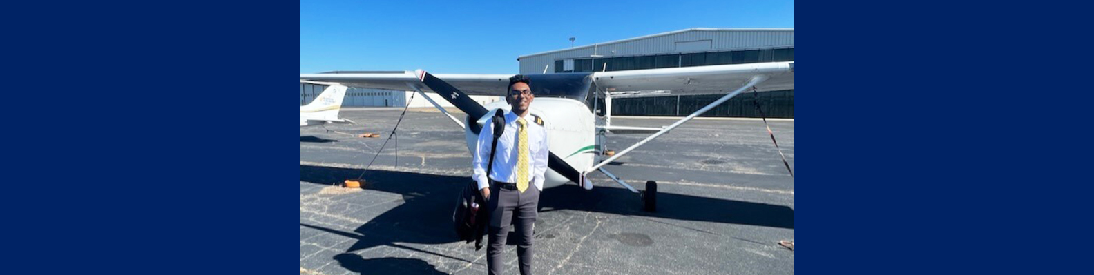 Student pilot in front of an airplane