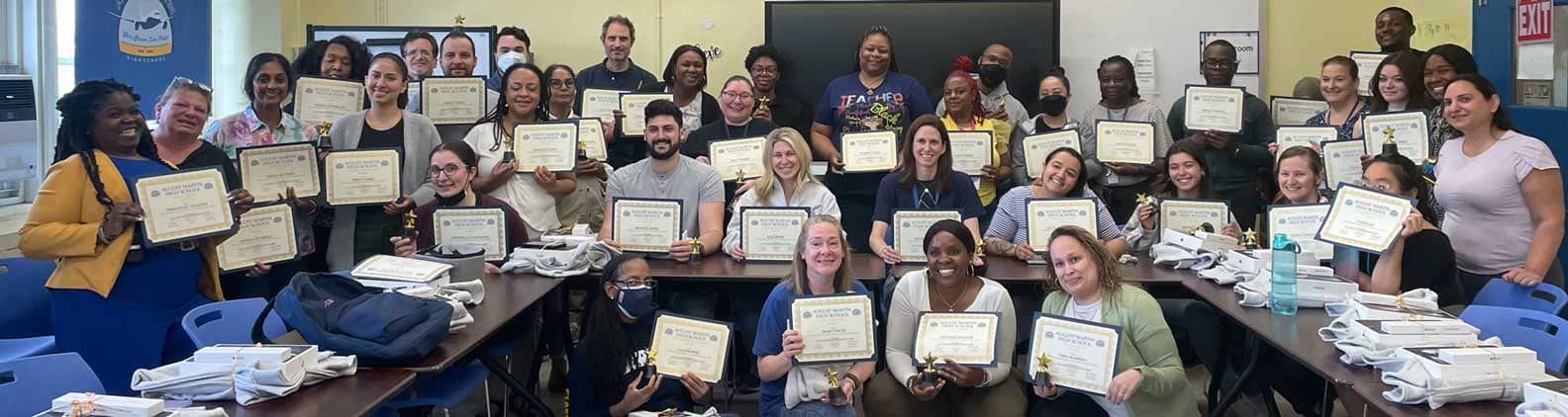 Group of staff holding up certificates