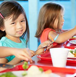 Two little girls eating lunch