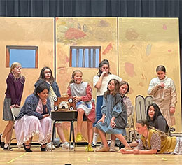 Students acting in a play on stage