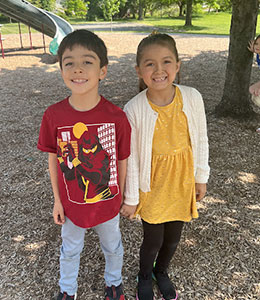 Two students smiling on the playground