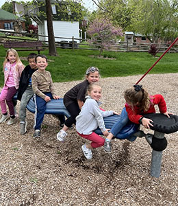 Six children on playground equipment