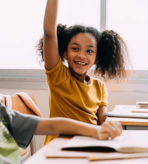 Girl raising her hand in a classroom