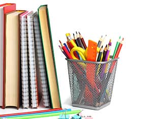 Books and notebooks next to a pencils, clips, and a wire container with school supplies in it