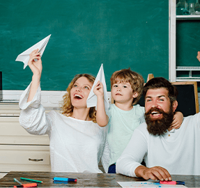 mom and dad playing with student