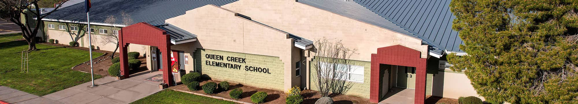 Students standing by the entrance of the school