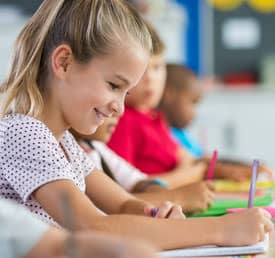 smiling student writing