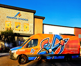 A+ Academy van next to school building