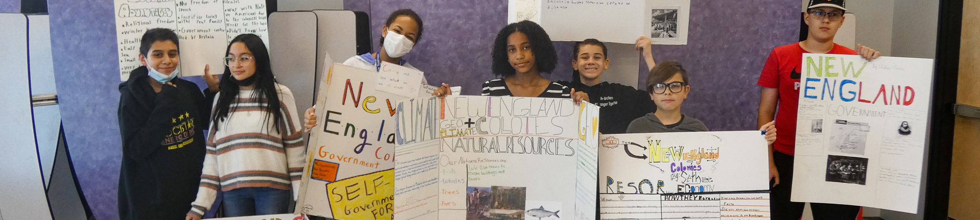 students holding posters