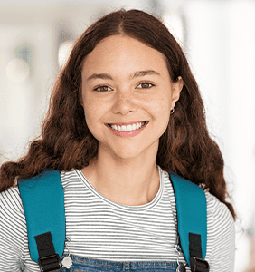Student smiling with a backpack on
