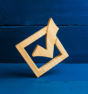 Wooden check mark on a blue background
