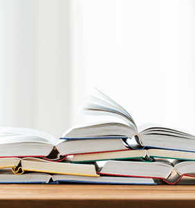 Stack of open books on a desk