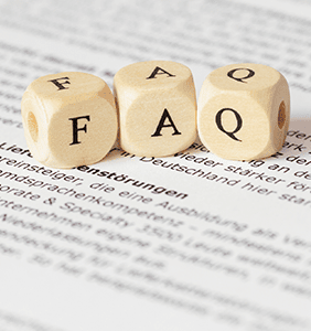 FAQ letter dice sitting on a book