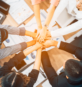 Hands on top of one another symbolizing team work