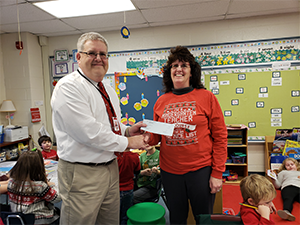Mrs. Mary Stanko receiving her check from Superintendent Terry Struble.