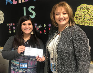 Kori Baines receives a PARSS grant check from Superintendent Dr. Hall.