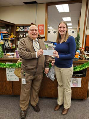 Dr. Toth presents check to Ms. Ellen Stolarski, middle school librarian.