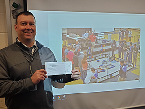 Matt Jones of the Warren Area School District holds his check of a recently approved grant.