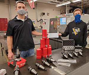 Colton Black, precision machine technology instructor for the WCCC and Hunter Gourley, a senior student in the machine technology program. Both are seen with some of the tooling purchased with the PARSS grant funds.