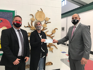 Thomas J. Samosky, superintendent, presents a check to Dustin Thompson, Dassa McKinney principal and Kimberley McBryar, Dassa McKinney STREAM technology teacher (the R is for reading).