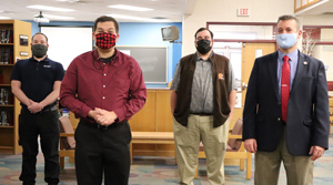 Superintendent Bill Vonada stands with the recipients of the PARSS grant. From left to right: Dan O’Brien, Colin Milne, Zack Bedee, and Bill Vonada. Not pictured: Gayle Mitchell. (photograph by Ava Fischer)