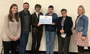 Pictured accepting the check during the December 12 school board meeting are Kelsey Nisula (advisor), Christian Taylor (advisor), Anthony Lash (student), T. J. Witmer (student), and Katie Heller (advisor).
