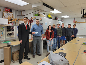 Left to right: Mark Bower (superintendent), Joe Kush (teacher), Sophie Kinney (student), Steven Sanner (student), Elliot Pletcher (student), Brandon Rhodes (student), John Hinzy (student), Cole Hostetter (student)