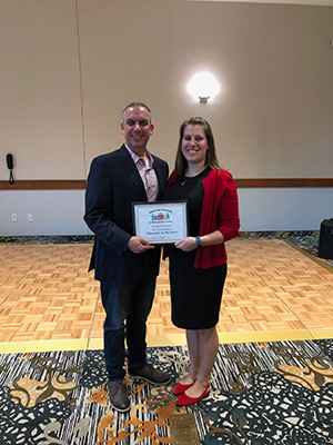 Susan Kilmer is accepting the award from Dr. Bottiglieri, superintendent of Wyalusing.