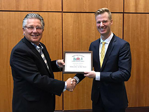 Wade Owlett is accepting the award from Executive Director Dr. Edward Albert.