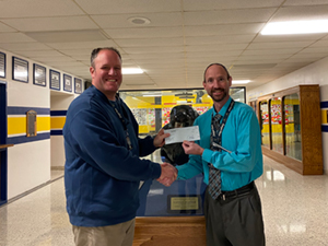 Mr. Greco (on the left), a biology teacher at Saegertown High School, receives a check from Principal Tom Baker.